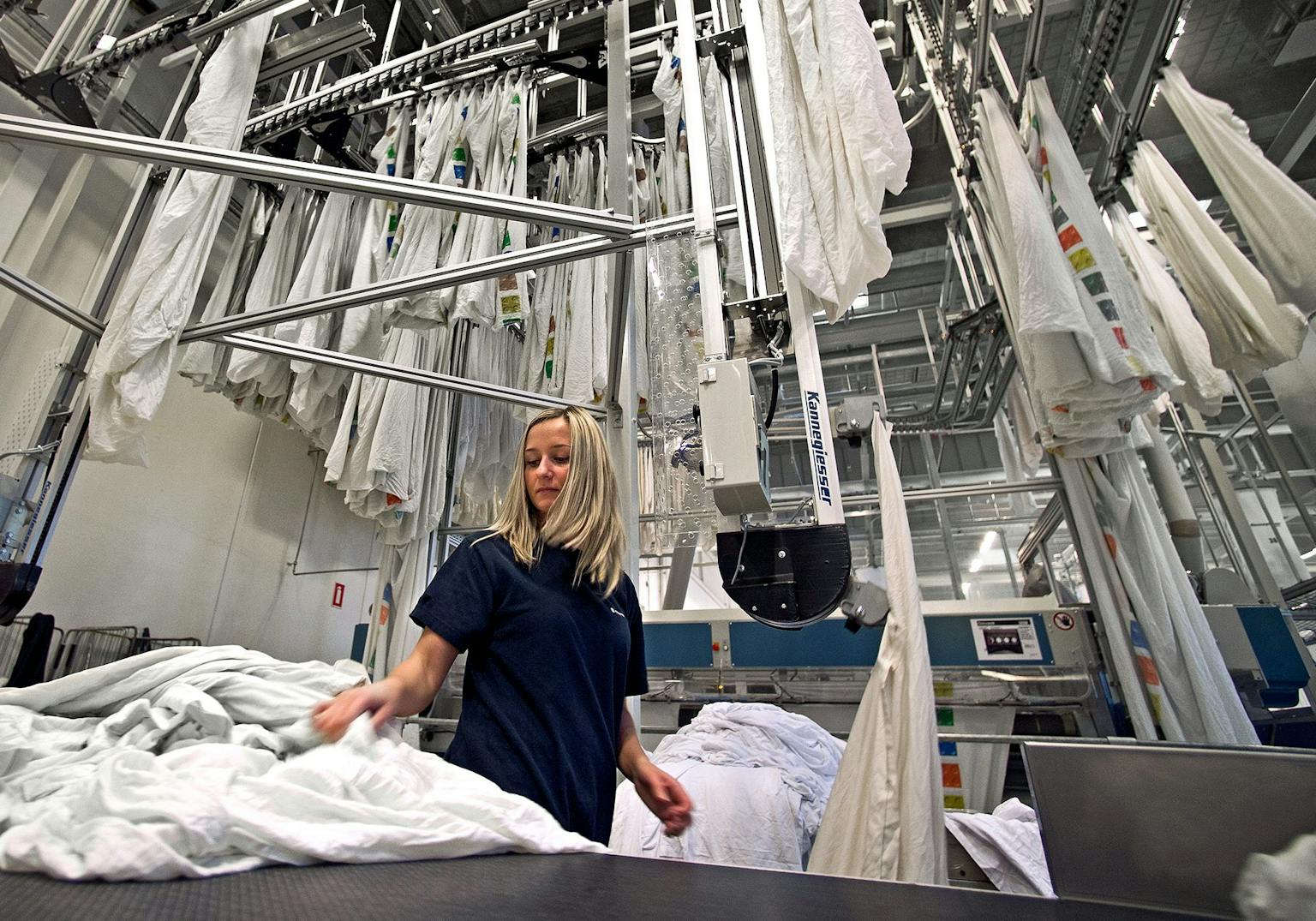 Female worker at professionel laundry service